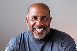 Closeup of man smiling in blue shirt