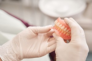 a close-up of dentures being held