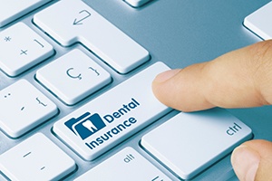 a person pushing a button that reads “dental insurance”