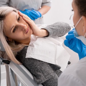 a woman speaking with her emergency dentist in Michigan City