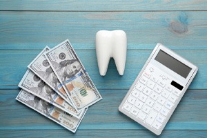 money, a tooth, and a calculator sitting on a counter