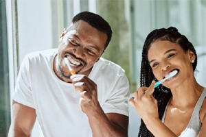 a couple brushing their teeth together