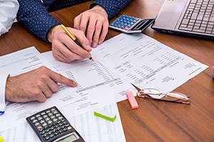 Patient in Michigan City reviewing tooth extraction costs with dental team 