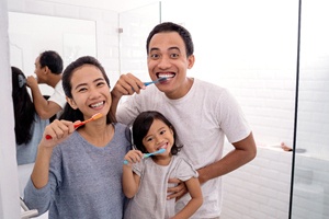 family brushing their teeth together