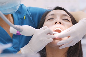 A woman receiving scaling and root planing