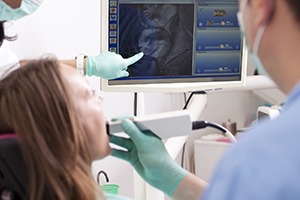 Dentist and patient looking at intraoral photos