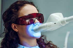 Woman having professional whitening treatment