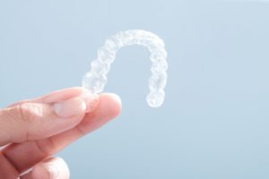 male hand Invisalign clear aligner