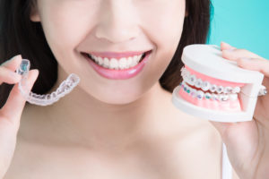 woman comparing conventional braces and invisalign