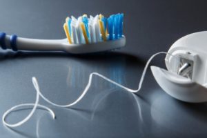 Toothbrush and floss on table by dentist near Michigan City