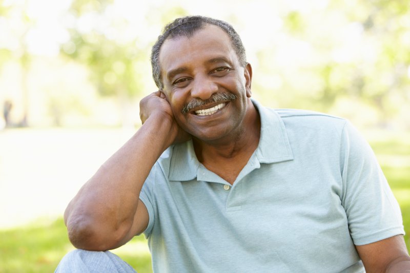 Older man smiling with his new dentures