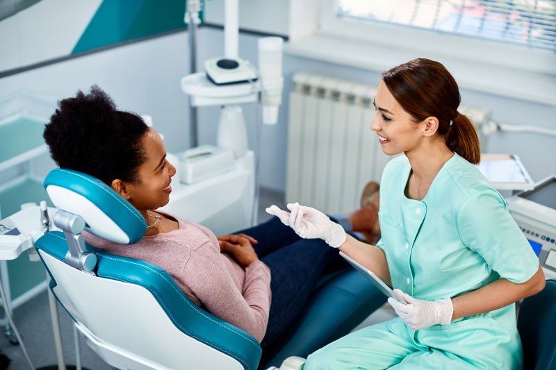 A patient consulting her orthodontist about Six Month Smiles