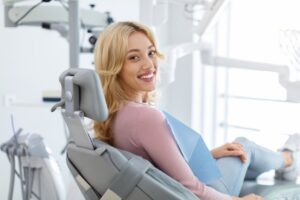 Woman smiling after getting her dental crown placed